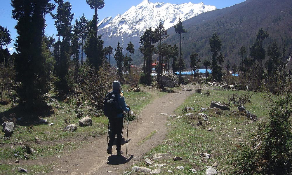 walking on manaslu trek route with backpack